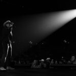 Jason Aldean performing on stage at Spark Arena during a concert.