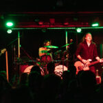 Band playing live on stage at The 13th Floor concert venue.