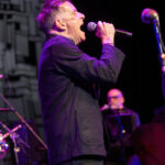 Deacon Blue singing passionately on stage during a concert at Bruce Mason Centre, Auckland, February.