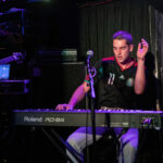 Harper Finn performing on keyboard at The 13th Floor concert venue in Wellington, NZ.