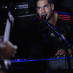 Harper Finn performing live at The 13th Floor, showcasing his musical talent during a concert.